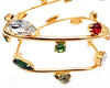 Gold metal swirl bangle with colorful Swarovski stones