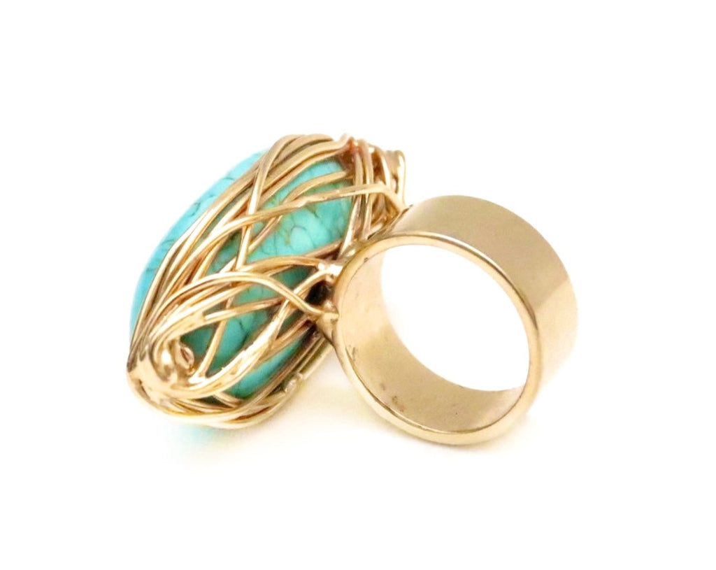 Gold twisted metal around turquoise stone ring