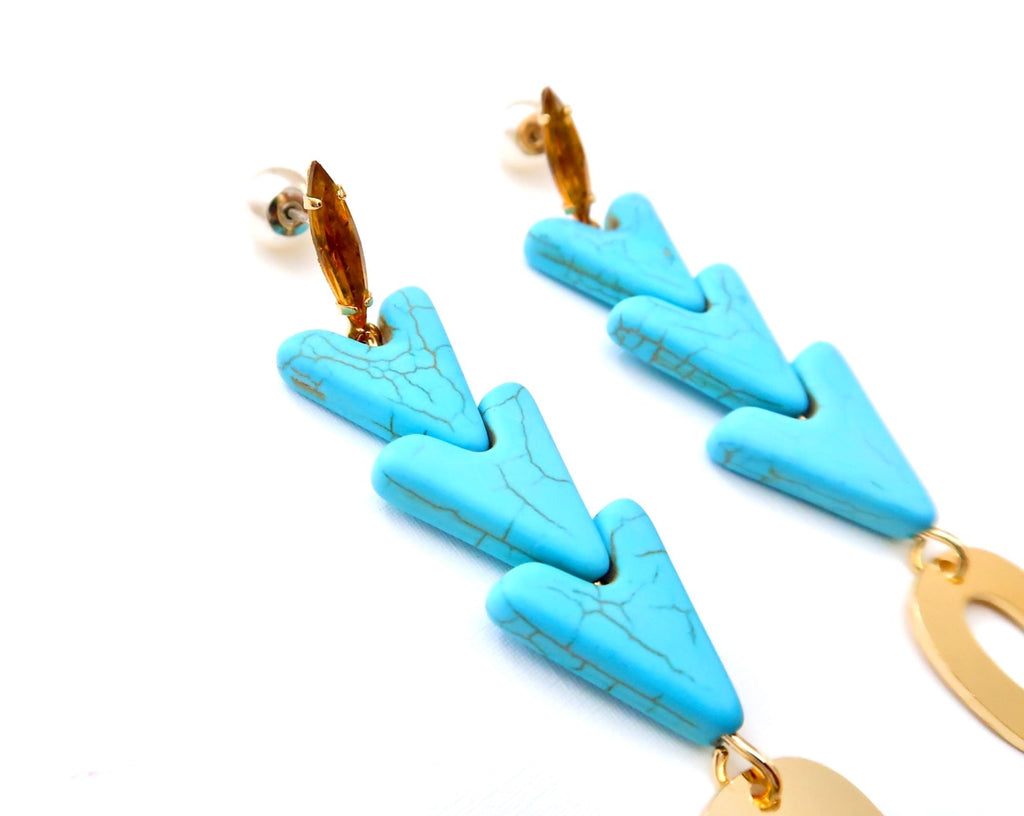 almond colored Swarovski stone with turquoise heart shaped accents and gold oval pendant