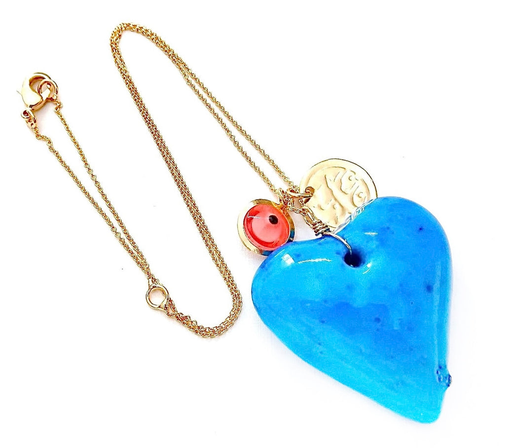dainty necklace with evil eye bead Persian coin and large blue stone heart