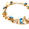 Gold chain with turquoise Swarovski stones and triangle cutout details