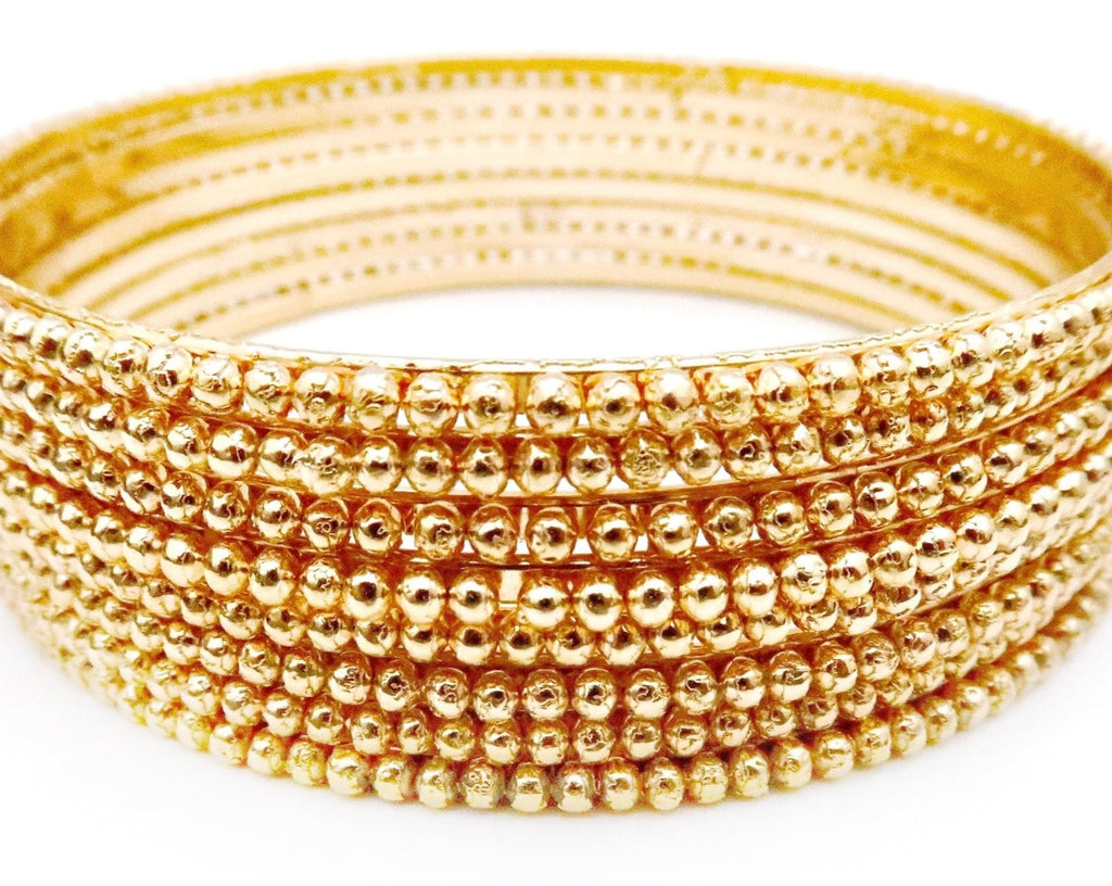 Gold bangles with ball details