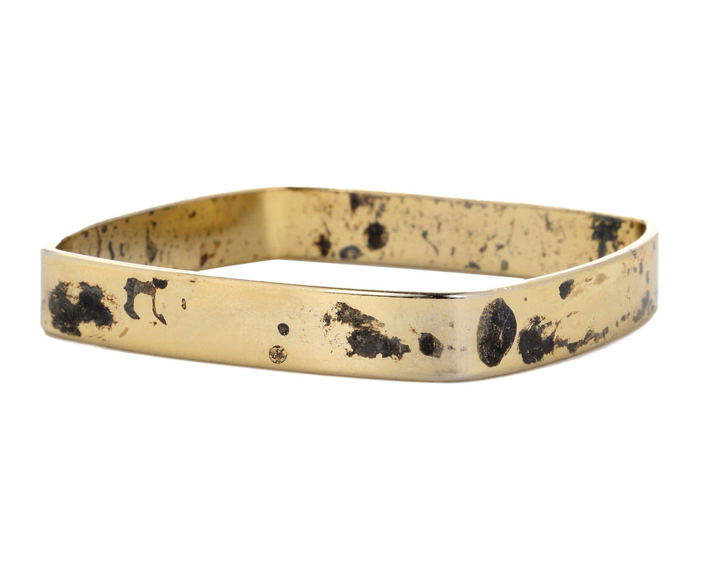 Small square gold bangle with acid finish